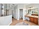Bright bathroom features a vanity with cabinets, framed mirror and glass enclosed shower, complemented by tile flooring at 31646 Baymont Loop, Wesley Chapel, FL 33543