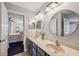 Elegant bathroom with double sinks and an adjacent room, offering convenience and style at 31646 Baymont Loop, Wesley Chapel, FL 33543