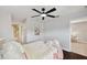Light, bright bedroom featuring a ceiling fan and ensuite bathroom at 31646 Baymont Loop, Wesley Chapel, FL 33543