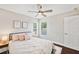 Bright bedroom with a comfortable bed, side tables, and a ceiling fan, creating a relaxing atmosphere at 31646 Baymont Loop, Wesley Chapel, FL 33543