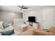 The bonus room is equipped with a ceiling fan, comfortable seating, and an entertainment center, ideal for entertainment at 31646 Baymont Loop, Wesley Chapel, FL 33543