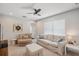 Inviting bonus room features a plush sofa, chair, and ottoman, complemented by a ceiling fan for added comfort at 31646 Baymont Loop, Wesley Chapel, FL 33543
