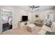 Bright bonus room with a ceiling fan, comfortable seating, and an entertainment center for relaxation and enjoyment at 31646 Baymont Loop, Wesley Chapel, FL 33543