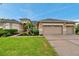 Charming home with a well-kept lawn, lush landscaping, and a convenient three-car garage at 31646 Baymont Loop, Wesley Chapel, FL 33543