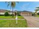 Attractive home with manicured lawn, complemented by a three-car garage and well-maintained landscaping at 31646 Baymont Loop, Wesley Chapel, FL 33543