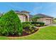 Beautifully landscaped front yard with a well maintained home and a two car garage at 31646 Baymont Loop, Wesley Chapel, FL 33543