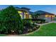 Well-maintained home exterior with lush landscaping and manicured lawn at 31646 Baymont Loop, Wesley Chapel, FL 33543