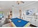 Bright game room featuring a blue pool table, modern lighting, and elegant decor at 31646 Baymont Loop, Wesley Chapel, FL 33543