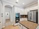 Modern kitchen with stainless steel appliances, granite countertops, and tile flooring at 31646 Baymont Loop, Wesley Chapel, FL 33543