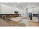 Well-lit kitchen featuring tile backsplash, white cabinetry, and stainless steel appliances at 31646 Baymont Loop, Wesley Chapel, FL 33543