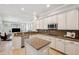 Bright kitchen featuring a breakfast bar and stainless steel appliances and tile backsplash at 31646 Baymont Loop, Wesley Chapel, FL 33543