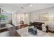 Open living room with dark wood floors, comfortable seating and ample lighting at 31646 Baymont Loop, Wesley Chapel, FL 33543