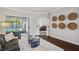 Cozy living room with dark wood floors and a view of the pool area at 31646 Baymont Loop, Wesley Chapel, FL 33543