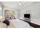 Spacious main bedroom features hardwood floors, a ceiling fan, and a cozy sitting area with bright windows at 31646 Baymont Loop, Wesley Chapel, FL 33543