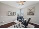 Modern office features neutral walls, hardwood floors, a ceiling fan, and a spacious work area with great light at 31646 Baymont Loop, Wesley Chapel, FL 33543