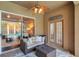 Cozy covered patio with a ceiling fan, and cushioned seating, offering a seamless transition to the outdoor pool area at 31646 Baymont Loop, Wesley Chapel, FL 33543