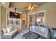 Cozy covered patio featuring a ceiling fan and comfortable seating, ideal for outdoor relaxation and entertainment at 31646 Baymont Loop, Wesley Chapel, FL 33543