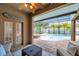 Relaxing outdoor space with ceiling fan and view of the screened lanai, which features a pool and spa at 31646 Baymont Loop, Wesley Chapel, FL 33543