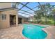 Screened-in pool and spa area featuring brick pavers and spacious lounging at 31646 Baymont Loop, Wesley Chapel, FL 33543