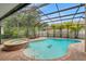 Serene screened-in pool and spa area, providing a private outdoor oasis for relaxation and recreation at 31646 Baymont Loop, Wesley Chapel, FL 33543