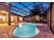 Wonderful in-ground screened pool surrounded by brick pavers and relaxing seating area at 31646 Baymont Loop, Wesley Chapel, FL 33543