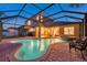 Inviting screened-in pool and spa offer a relaxing outdoor retreat with ample space for lounging and entertaining at 31646 Baymont Loop, Wesley Chapel, FL 33543