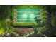 Aerial view of shuffleboard courts surrounded by lush greenery and landscaping at 31646 Baymont Loop, Wesley Chapel, FL 33543