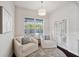 Sunroom featuring two chairs, accent rug, natural lighting and a view of the pool at 31646 Baymont Loop, Wesley Chapel, FL 33543