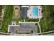 Aerial view of community pool and playground with ample parking at 38120 Shale Stone Ct, Zephyrhills, FL 33540