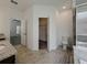 Bathroom featuring tile floors, granite countertop, toilet, glass shower, and walk-in closet at 38120 Shale Stone Ct, Zephyrhills, FL 33540