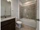 Bathroom with granite vanity, tub with shower, and neutral-toned tile at 38120 Shale Stone Ct, Zephyrhills, FL 33540