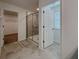 Bathroom with a glass-enclosed shower and neutral tile, offering a clean and modern aesthetic at 38120 Shale Stone Ct, Zephyrhills, FL 33540