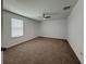 Bedroom featuring neutral carpet, ceiling fan, and natural light from the window at 38120 Shale Stone Ct, Zephyrhills, FL 33540