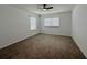 Bedroom featuring neutral carpet, ceiling fan, and two windows at 38120 Shale Stone Ct, Zephyrhills, FL 33540