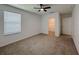 Bedroom featuring neutral carpet, ceiling fan, and closet at 38120 Shale Stone Ct, Zephyrhills, FL 33540