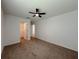 Spacious bedroom featuring a ceiling fan, neutral walls, and carpet flooring, creating a comfortable and inviting space at 38120 Shale Stone Ct, Zephyrhills, FL 33540