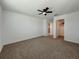 Bedroom featuring neutral carpet, ceiling fan, and closet at 38120 Shale Stone Ct, Zephyrhills, FL 33540