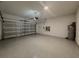 A spacious garage with an epoxy floor, offering a clean and durable surface for parking and storage at 38120 Shale Stone Ct, Zephyrhills, FL 33540