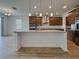 Bright and airy kitchen featuring a center island, modern lighting, and stainless steel appliances at 38120 Shale Stone Ct, Zephyrhills, FL 33540