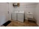 Laundry room equipped with a washer, dryer, utility sink, and storage shelf at 38120 Shale Stone Ct, Zephyrhills, FL 33540