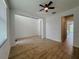 Open-concept living room with wood-look tile flooring and a view into the kitchen at 38120 Shale Stone Ct, Zephyrhills, FL 33540