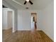 Spacious living room showcasing wood-look tile flooring and seamless transitions to other rooms at 38120 Shale Stone Ct, Zephyrhills, FL 33540