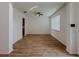 Living room featuring wood-look tile flooring, ceiling fan, and natural light from a window at 38120 Shale Stone Ct, Zephyrhills, FL 33540