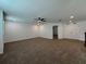 Large loft area featuring neutral carpet and a view of two closets at 38120 Shale Stone Ct, Zephyrhills, FL 33540