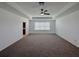 A bright main bedroom with a tray ceiling, ceiling fan, neutral walls, and a window offering natural light and comfort at 38120 Shale Stone Ct, Zephyrhills, FL 33540