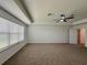 A large main bedroom with a ceiling fan, neutral walls, and a window offering natural light and comfort at 38120 Shale Stone Ct, Zephyrhills, FL 33540