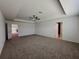 A large main bedroom with a ceiling fan, neutral walls, and a window offering natural light and comfort at 38120 Shale Stone Ct, Zephyrhills, FL 33540