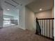 Second-floor view with carpet, iron railing staircase, and plenty of natural light at 38120 Shale Stone Ct, Zephyrhills, FL 33540