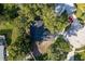 An aerial view of the home showing the roof and tree coverage at 399 Walnut Ct, Palm Harbor, FL 34683