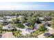 Lovely aerial view of a neighborhood showcasing tree-lined streets, well-maintained lawns, and mature landscaping at 399 Walnut Ct, Palm Harbor, FL 34683